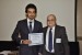 Dr. Nagib Callaos, General Chair, giving Dr. Khalid N. Alhayyan the best paper award certificate of the session "Society, Education and Information Technologies (ICSIT / ICETI)." The title of the awarded paper is "Discovering and Analyzing Important Real-Time Trends in Noisy Twitter Streams."